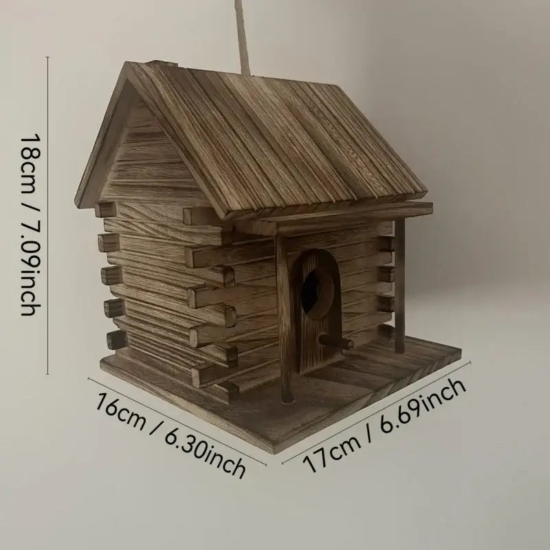 Rustic wooden birdhouse with slanted roof and arched entrance designed for hummingbirds and small birds by decorbites