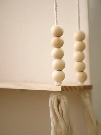 Decorbites™ rustic wooden wall shelf with natural-toned wooden beads and white macrame cords for hanging plant storage
