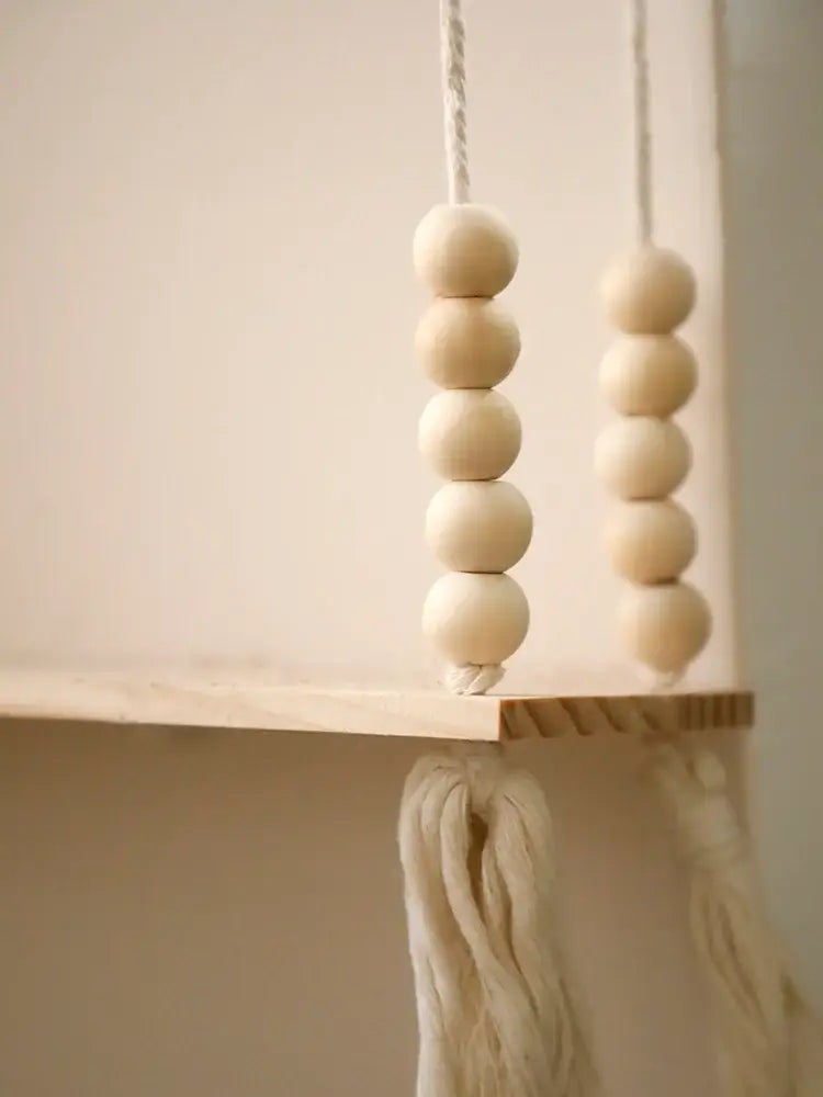 Decorbites™ rustic wooden wall shelf with natural-toned wooden beads and white macrame cords for hanging plant storage