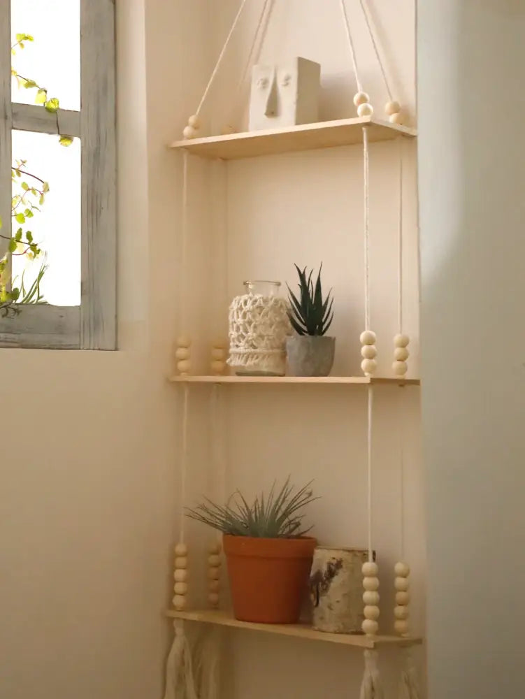 DecorBites rustic wooden wall shelf with three wooden tiers hanging by macrame cords with cream wooden beads