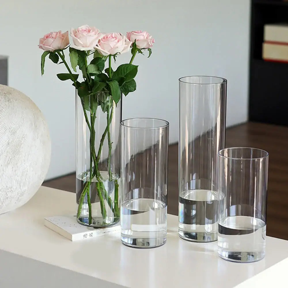 Decorbites shatterproof clear acrylic cylinder vases in varying heights with pink roses and water inside