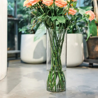 DecorBites™ shatterproof clear acrylic cylinder vase holding peach-colored roses in a clear acrylic cylinder design