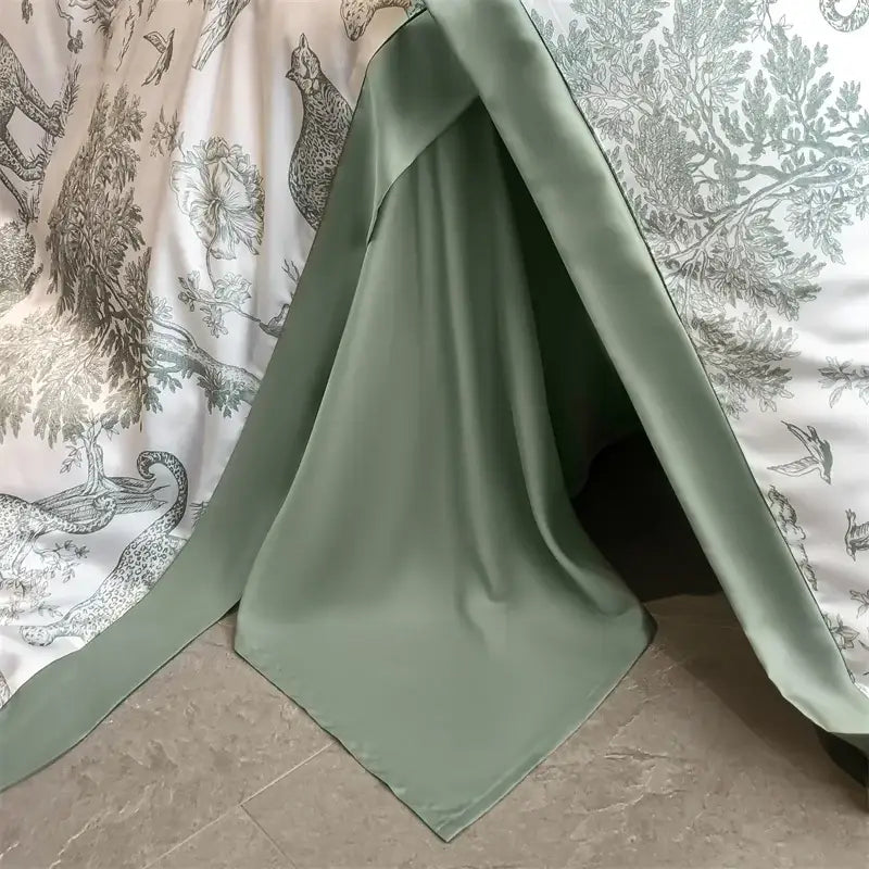 A soft sage green eucalyptus fiber duvet cover draped to form a cozy tent-like bed sheet structure