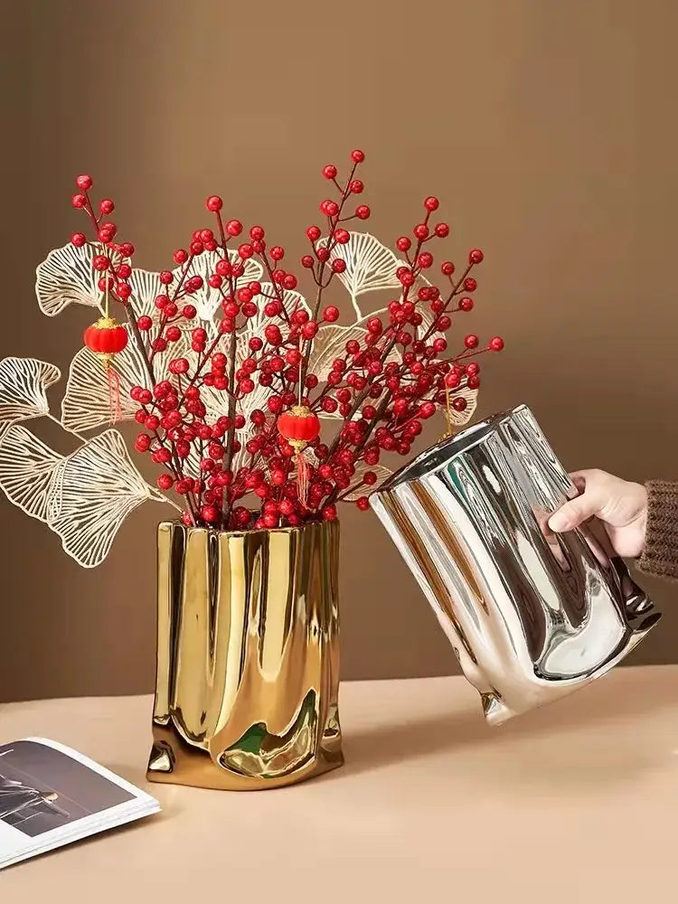 DecorBites™ silver ruffled ceramic flower vase in golden metallic with ribbed design holding red berries and white ginkgo leaves