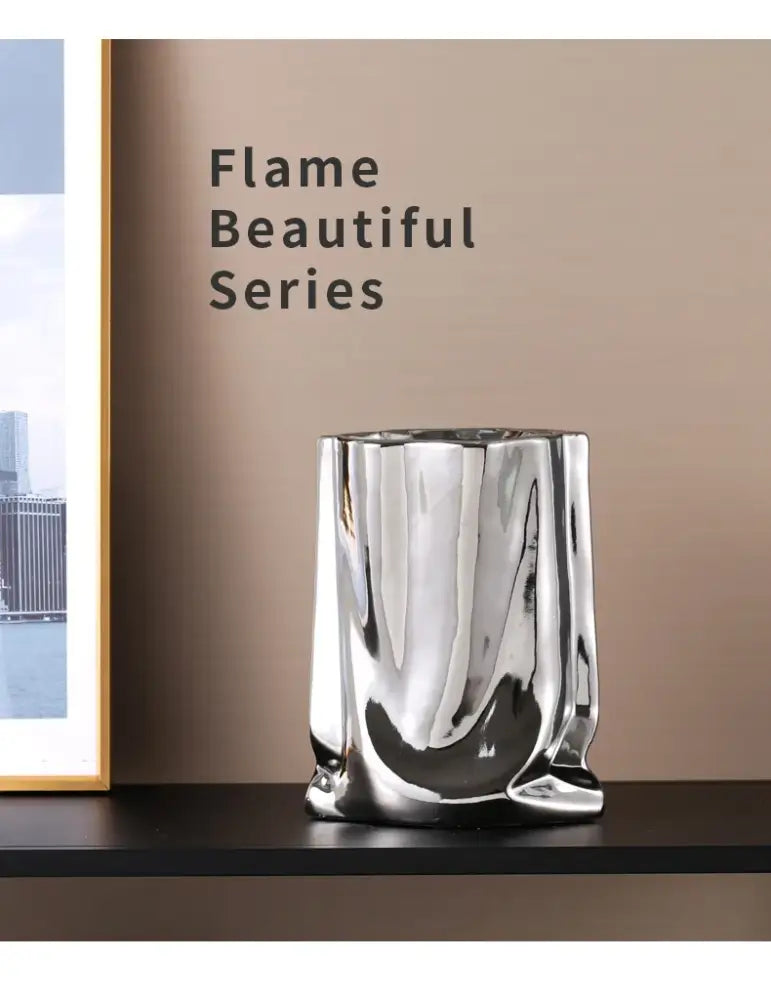 Shiny silver ruffled flower vase made of ceramic with a flame-like sculpted design by DecorBites™