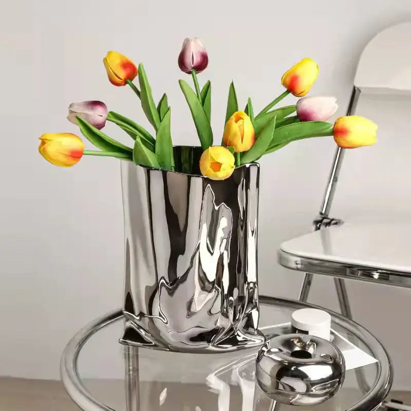 Shiny silver ruffled ceramic flower vase by DecorBites holding colorful tulips with a sculpted wavy surface