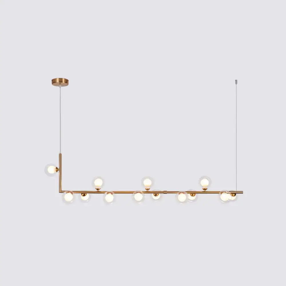 DecorBites sleek brass pendant light with clear glass globes in a linear hanging island design for dining room