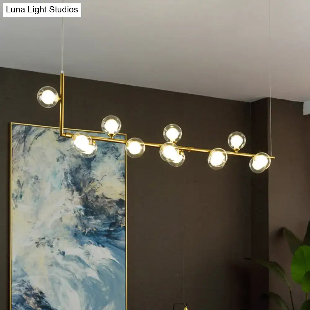 Decorbites sleek glass pendant light with gold-toned spherical bulbs on horizontal bar for dining room hanging island