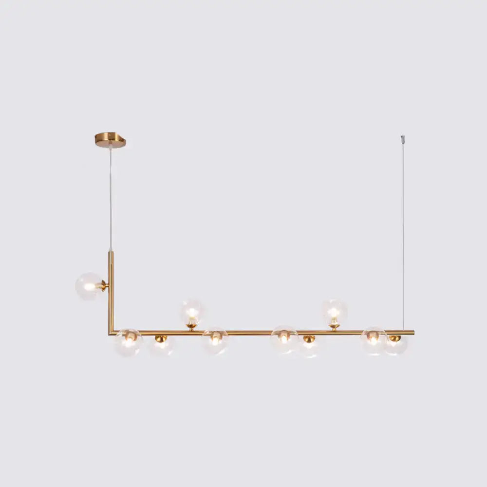 Modern brass pendant light with clear glass globe bulbs by DecorBites for dining room hanging island design