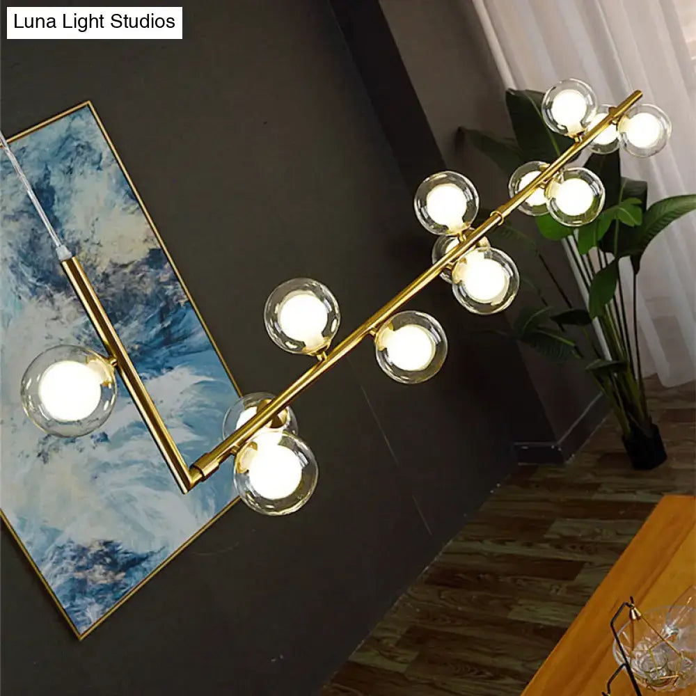 Gold-toned DecorBites™ pendant light with clear glass globes for dining room hanging island design