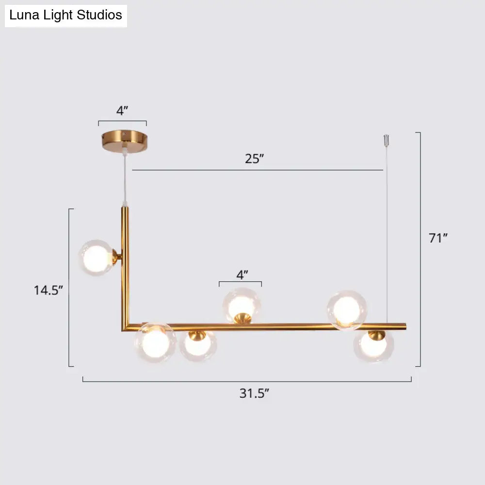 Modern gold-toned glass pendant light with five spherical bulbs in l-shaped hanging island design for dining room