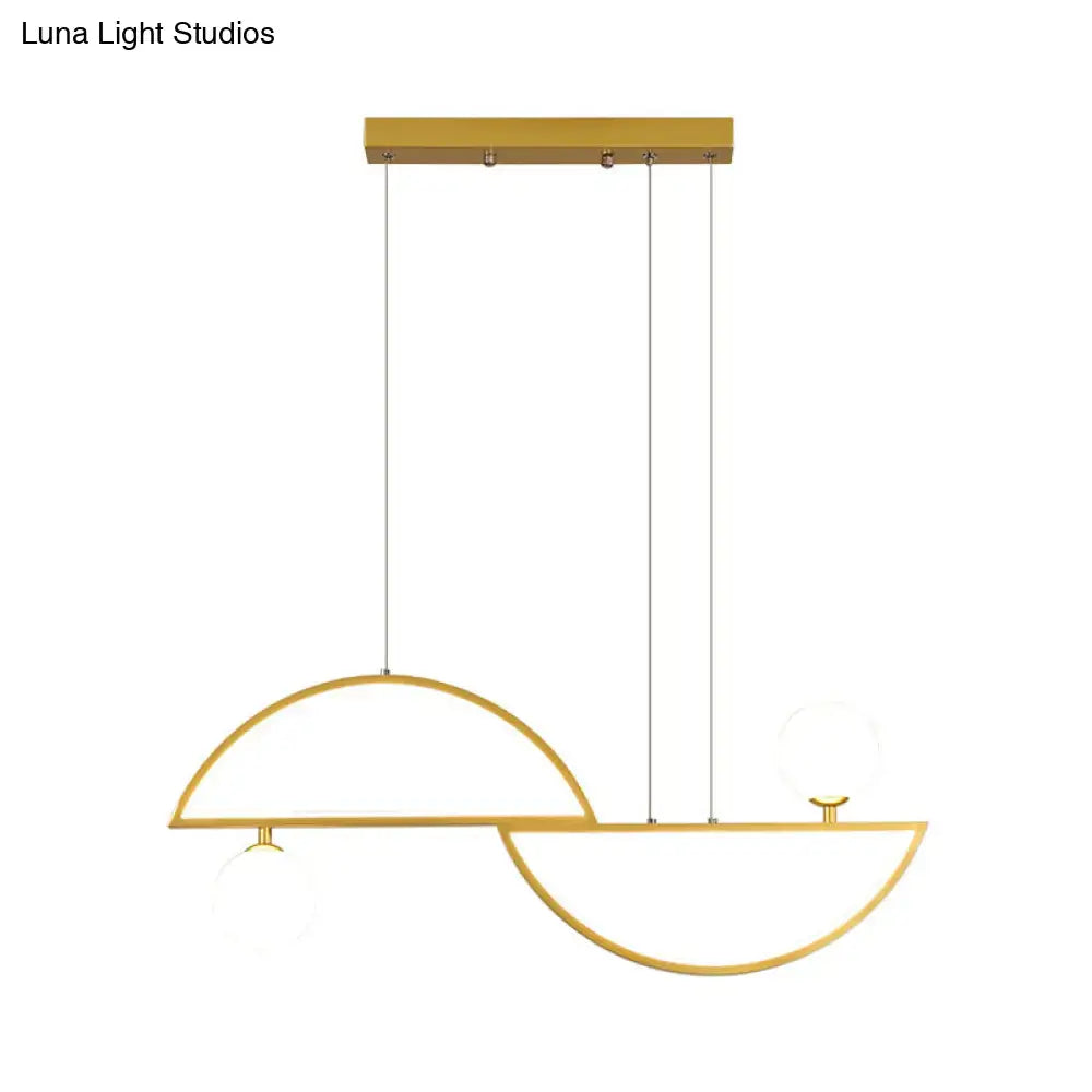 Modern gold-toned ceiling light with sleek semi-circular metal frames and frosted glass globe accents for dining room island light fixture