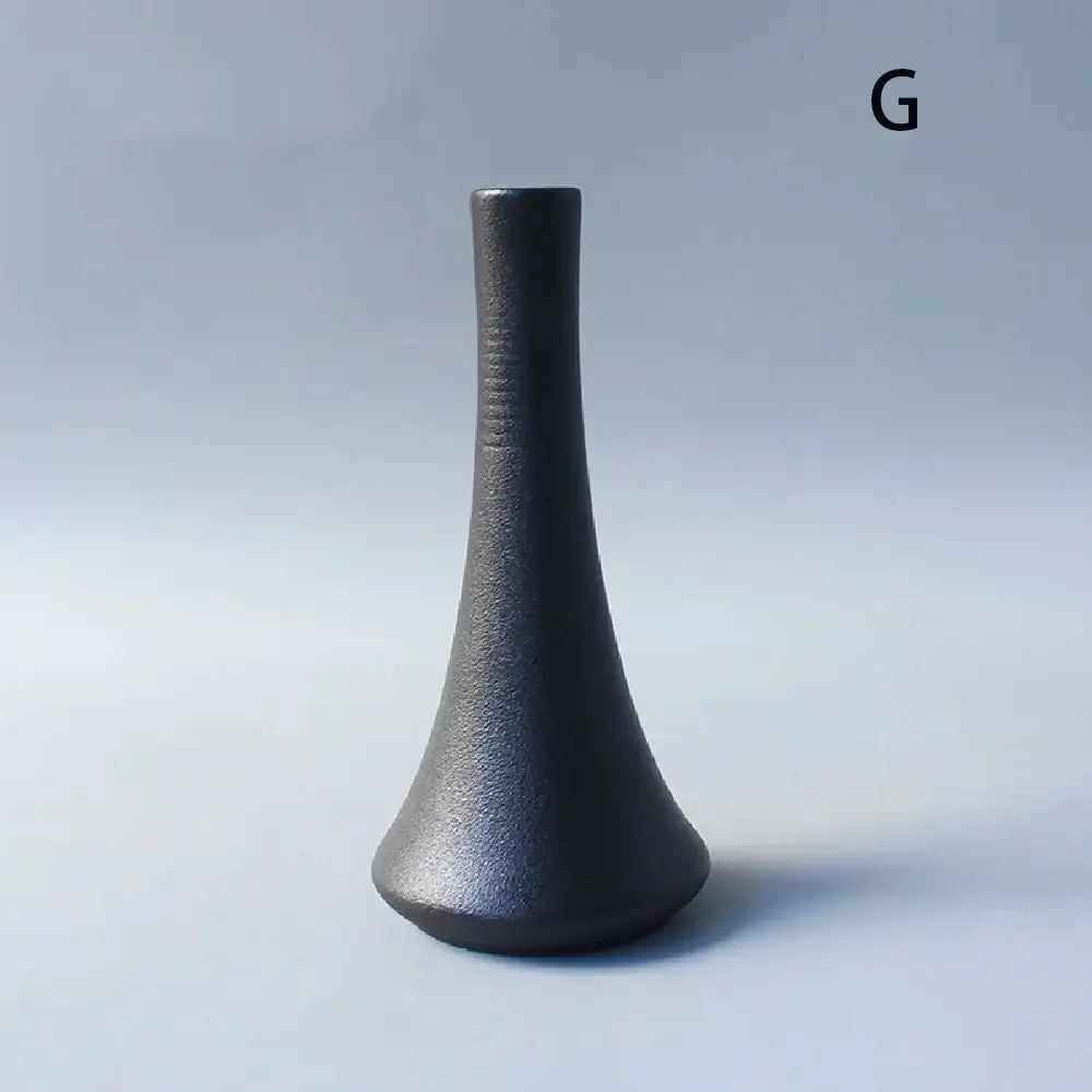 A sleek matte black ceramic small vase with slender neck and flared base for elegant japanese home decor