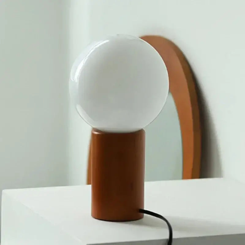 DecorBites™ small table lamp with frosted white glass bulb and cylindrical wooden base for minimalist decor