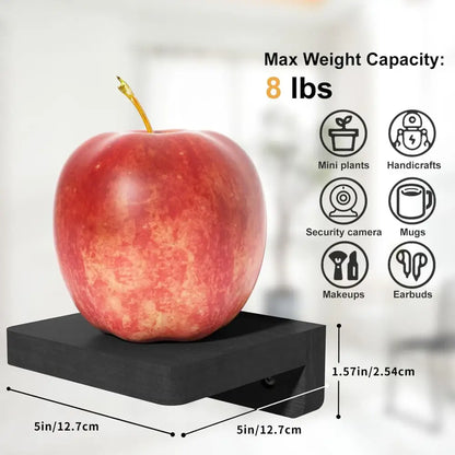 A vibrant red apple with a golden stem on a sleek black decorbites™ 4-pack small floating wood shelves platform
