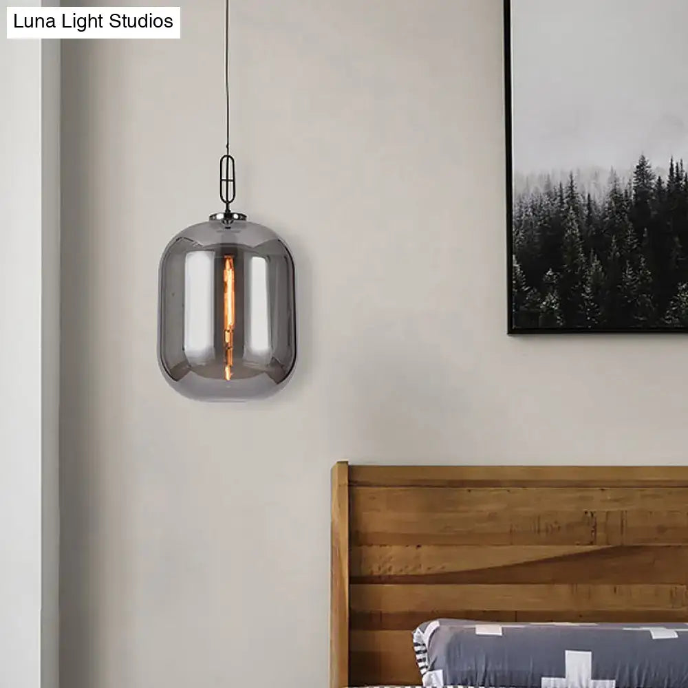 A decorbites™ smoke gray and cognac glass pendant lamp with smoked glass and black metal chain suspension
