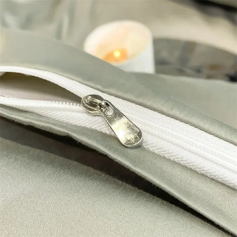 Silver-toned zipper pull on light gray satin fabric of DecorBites™ soft Egyptian cotton duvet cover 1000TC bedding set