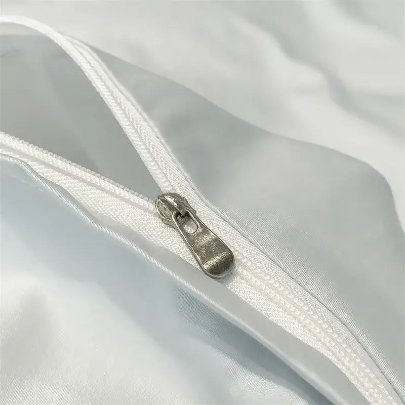 Silver-toned zipper pull on white satin-like fabric of decorbites™ soft egyptian cotton duvet cover with 1000tc