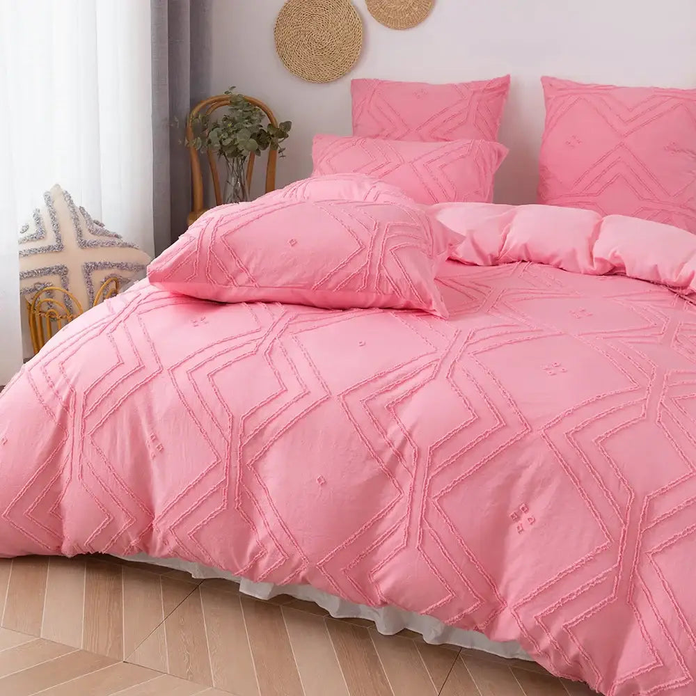 Pink quilted duvet cover set with geometric embroidery and white ruffled hem made of soft microfiber by DecorBites