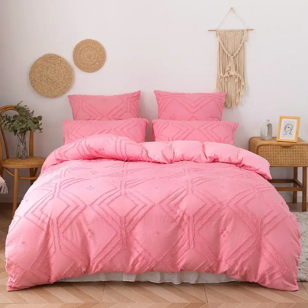 Pink quilted duvet cover set with geometric embroidery made of soft tufted microfiber by DecorBites