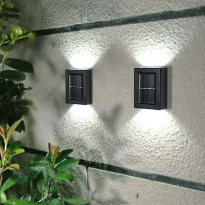 Black rectangular solar-powered decorbites™ wall sconces with integrated led lights for outdoor led garden decoration