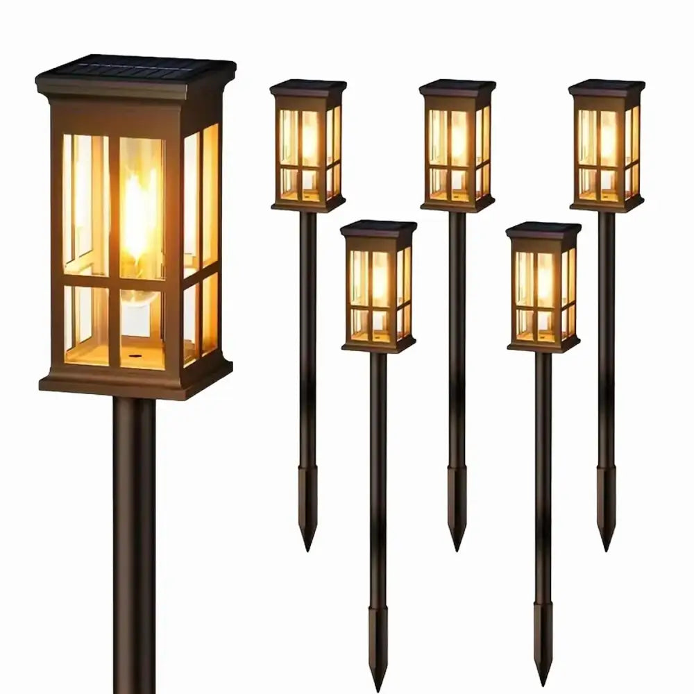 Set of six bronze-finished DecorBites™ solar pathway lights with warm yellow glass panels and black metal stakes