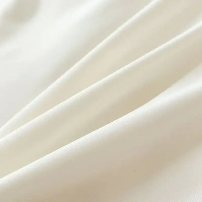 Soft creamy white solid color brush fabric duvet cover with smooth glossy texture and gentle folds from decorbites bedding set