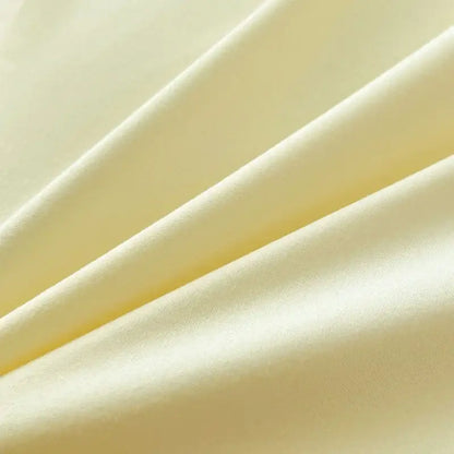 Soft pale yellow solid color brush fabric duvet cover with a smooth glossy finish in a decorbites bedding set