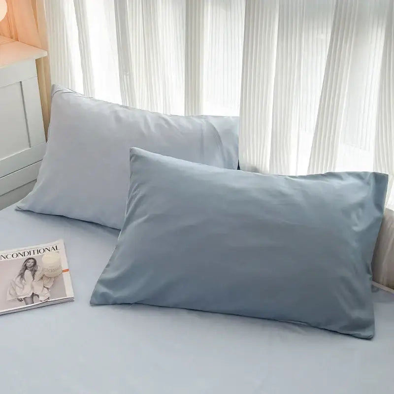 Two light blue solid color pillowcases with smooth brush fabric finish from the decorbites duvet cover set