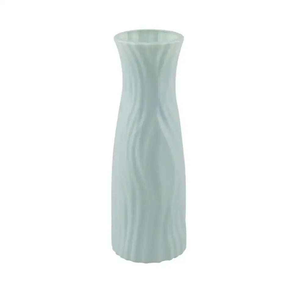 A sleek light green solid color plastic flower vase with smooth wavy texture for home decor by decorbites