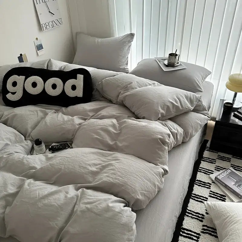 Black and white good word pillow with textured plush fabric complementing solid cotton bedding set decorbites