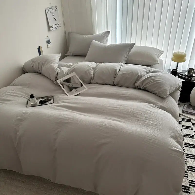 Decorbites™ solid cotton bedding set featuring an off-white duvet cover with soft texture and matching pillows neatly arranged