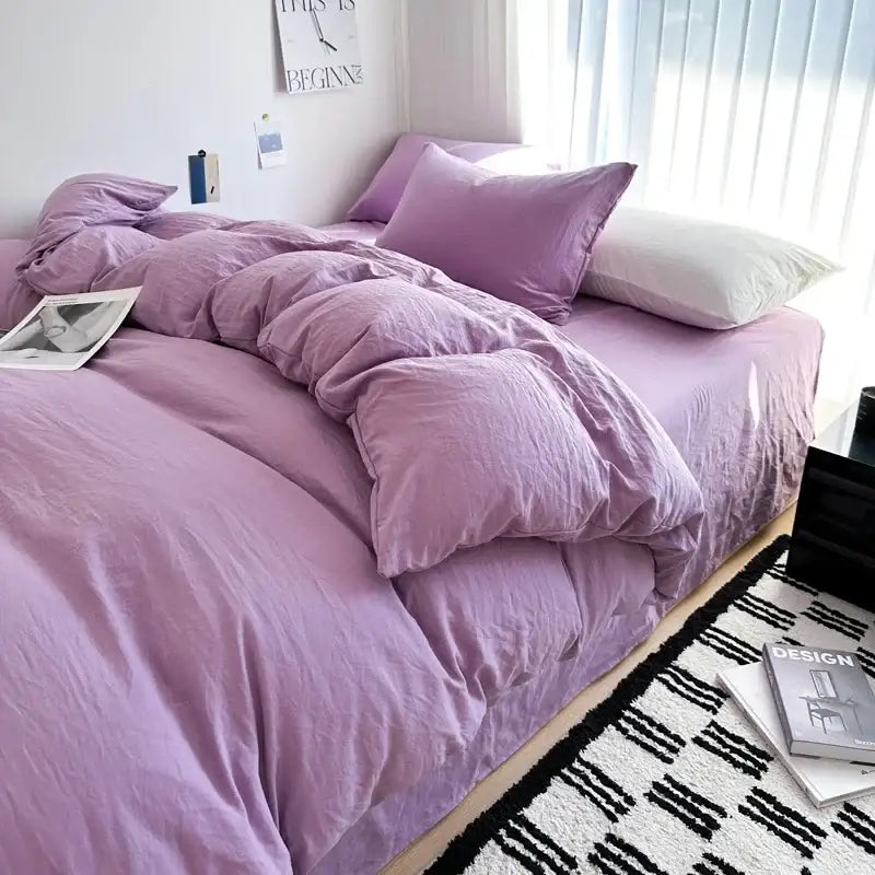 Purple quilted solid cotton bedding set by DecorBites with matching pillows and white accent pillow in soft fabric