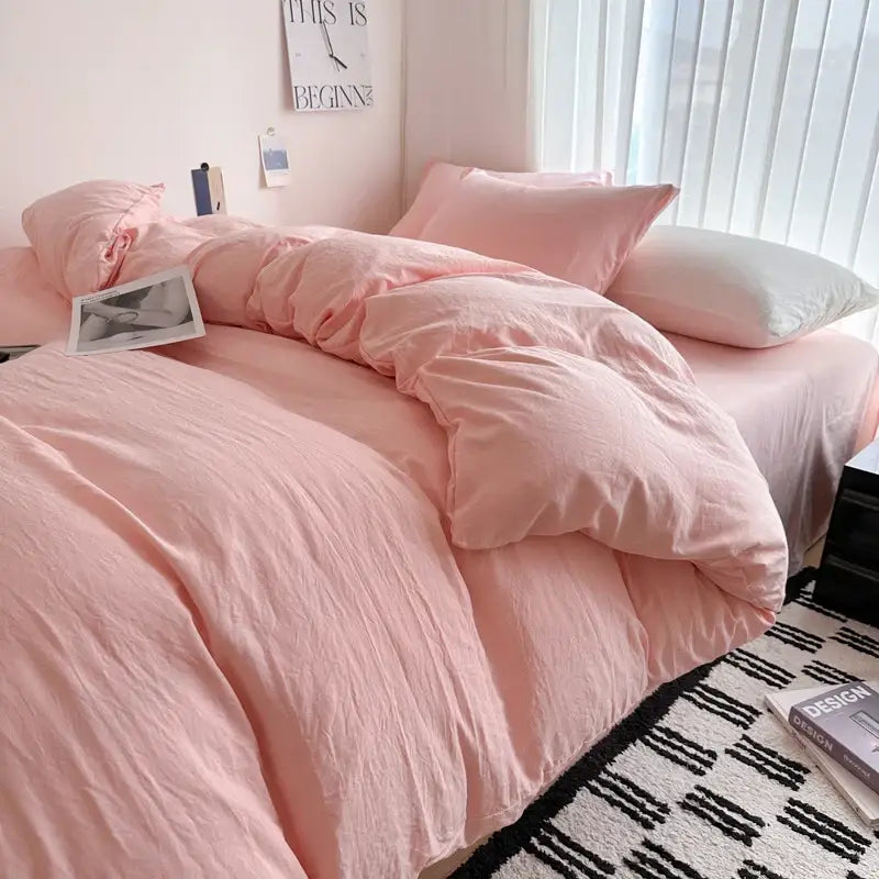 Soft pink solid cotton bedding set with duvet cover and matching pillows featuring a cozy slightly wrinkled texture