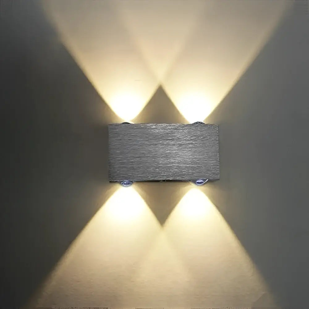 DecorBites™ Sphera modern gray textured stone wall sconces with warm LED lights casting symmetrical beams