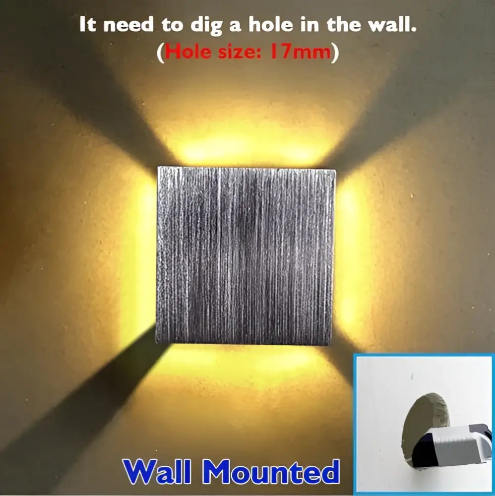 Decorbites sphera wall sconces silver brushed metal cube with warm yellow light casting angular beams