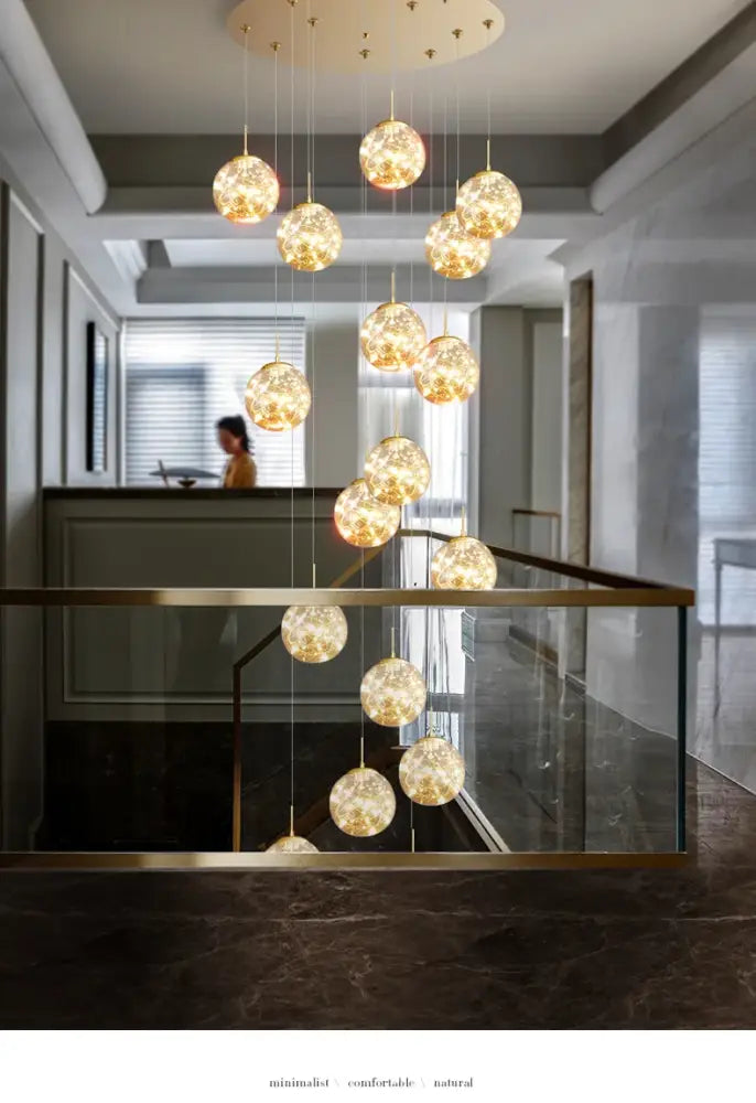 Golden crystal ball chandelier with textured crackled glass balls cascading from a circular ceiling fixture by decorbites