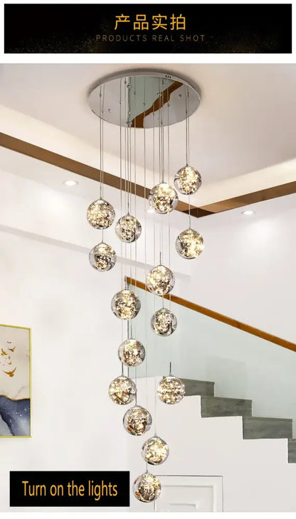 A modern DecorBites spiral crystal ball chandelier light with multiple reflective metallic glass orbs hanging in a circle