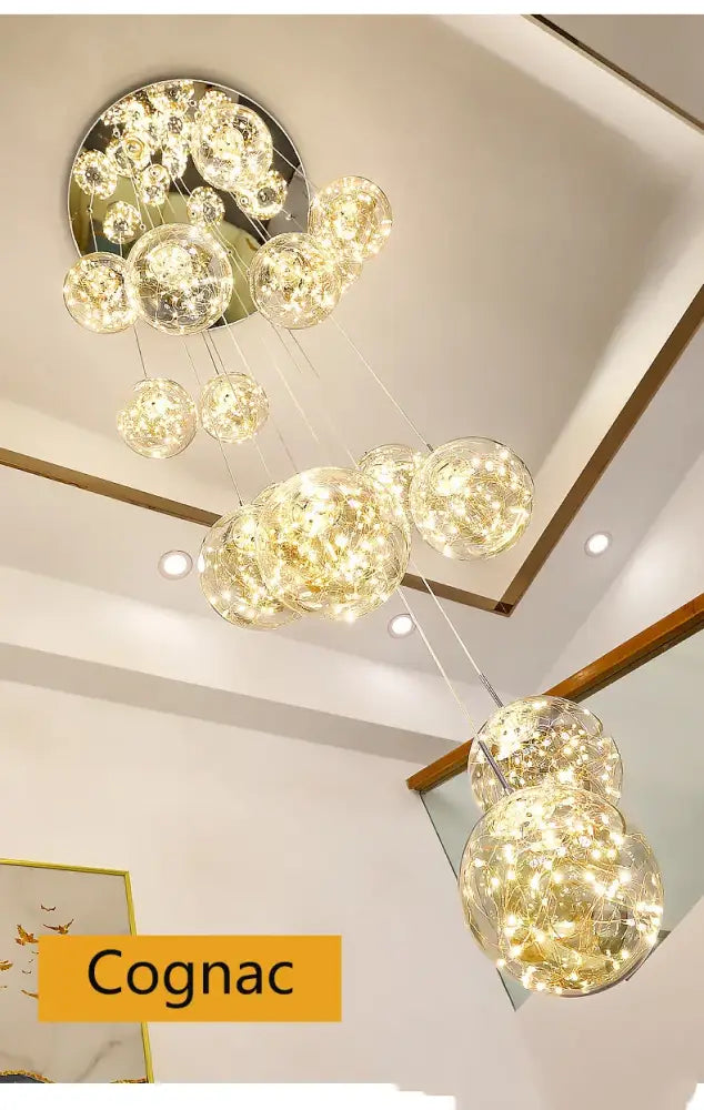 A modern DecorBites™ spiral crystal ball chandelier light with multiple glass orbs and internal led lighting suspended from a metallic base