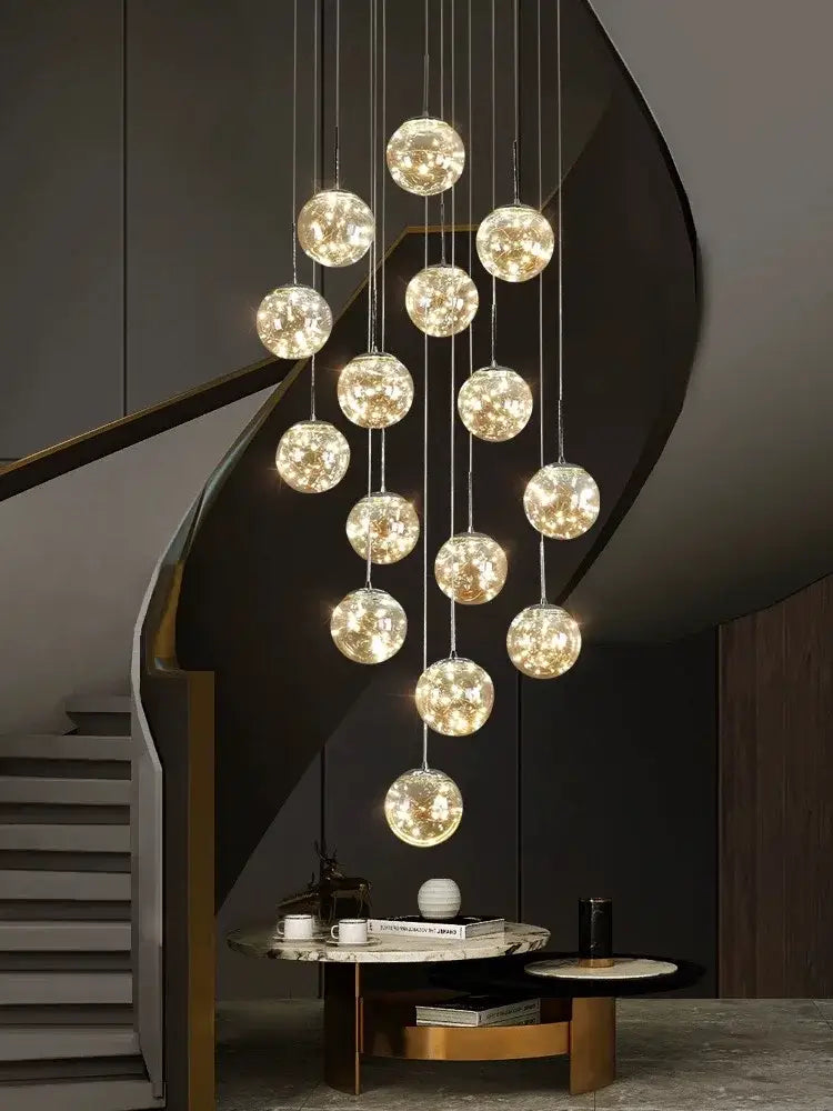 Decorbites™ spiral crystal ball chandelier light with multiple warm glowing glass orbs suspended by thin cables