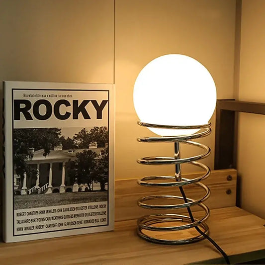 Decorbites™ spring glass table lamp with glowing white globe and polished chrome spiral base for modern lighting