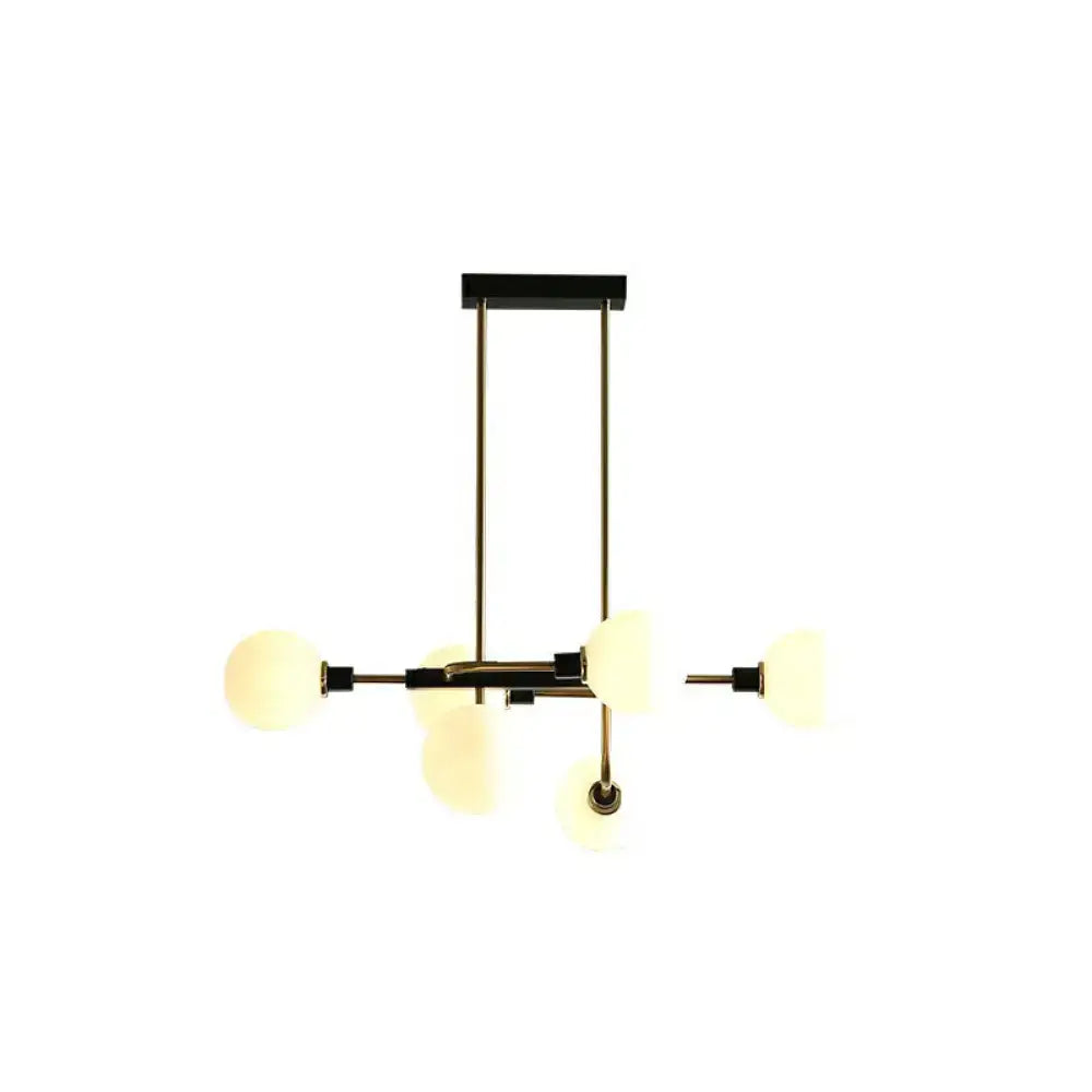 Modern brass and black sputnik hanging island light with frosted glass globe shades for dining room decor