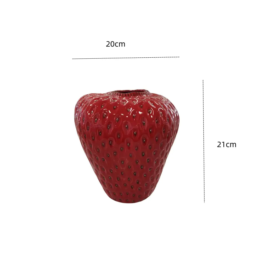 A glossy red ceramic vase shaped like a strawberry with seed-like details from DecorBites™ for kids room