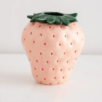 Decorbites™ pink ceramic strawberry shaped planter pot with red seed dots and green leafy top for decorative use