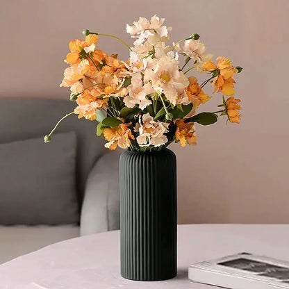 Decorbites™ striped ceramic-like plastic vase in black holding orange and cream artificial flowers bouquet