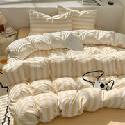 Cream and beige striped quilt set with pillowcases and bed sheet featuring a soft puffy texture by decorbites