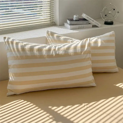 Cream and white striped pillowcases made of soft lightweight fabric from DecorBites™ striped quilt set with bed sheet