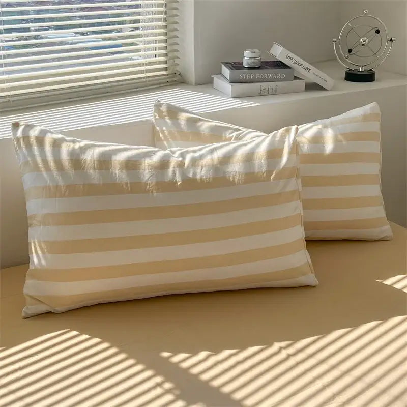 Cream and white striped pillowcases made of soft lightweight fabric from DecorBites™ striped quilt set with bed sheet