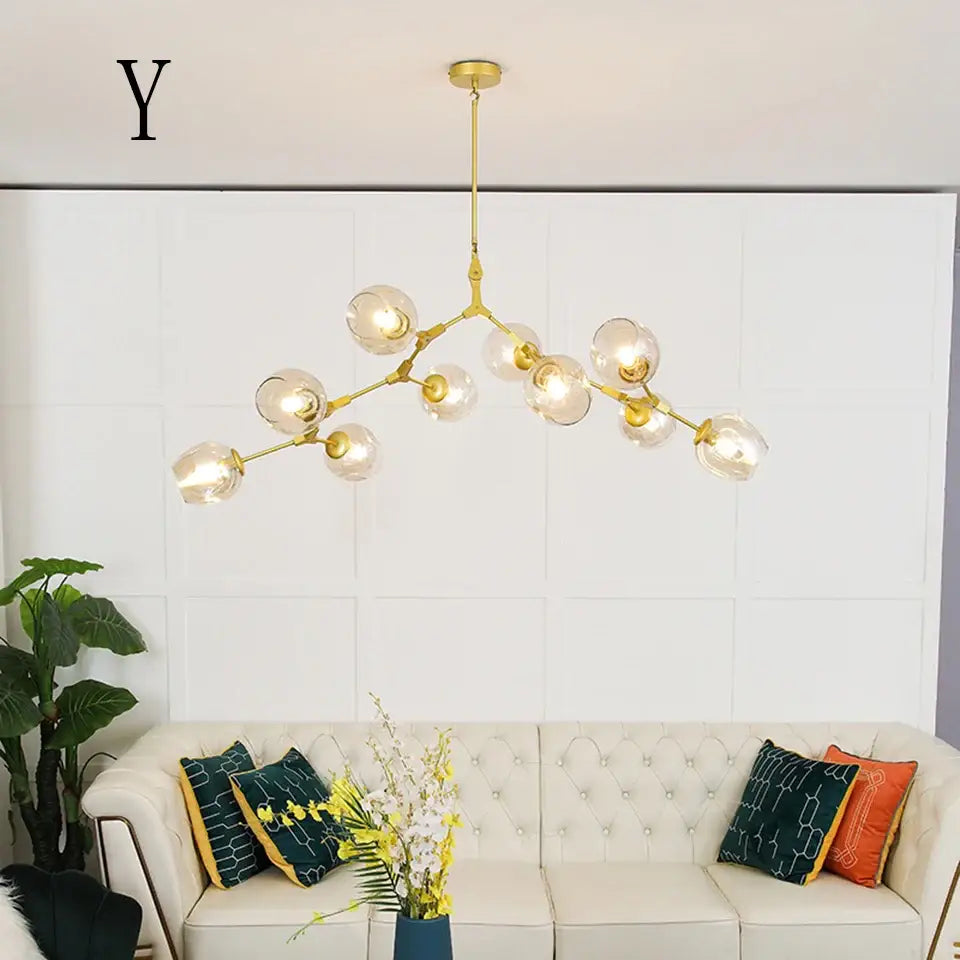 Gold-toned DecorBites™ modern chandelier lighting with clear glass globe bulbs in a branching design for dining and living rooms