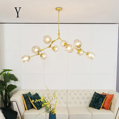 Gold-toned DecorBites™ modern chandelier lighting with clear glass globe bulbs in a branching design for dining and living rooms